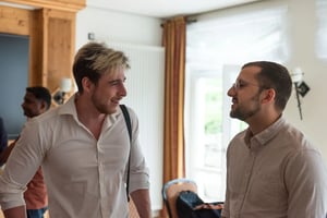 Zwei Männer unterhalten sich miteinander bei einem Firmenevent.